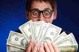 loans man smiling holding loads of cash
