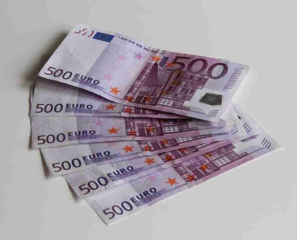 A stack of 500 euro banknotes on a white background, symbolizing the need for a 3000 loan.