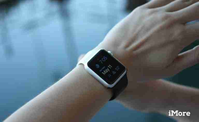 A person checks the time and weather on their smartwatch displaying 10:15, cloudy skies, and 76 degrees, despite having bad credit mobile phone contracts.