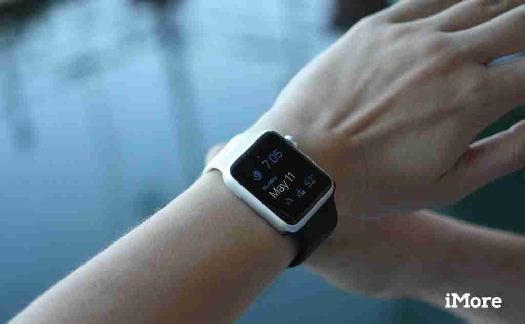 A person checks the time and weather on their smartwatch displaying 10:15, cloudy skies, and 76 degrees, despite having bad credit mobile phone contracts.