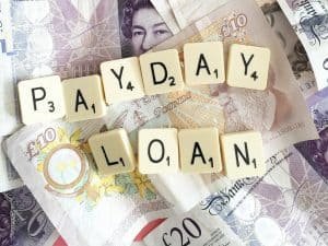 Capital Cash Payday Loans scrabble letters on top of cash notes