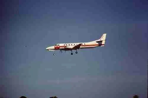 Commercial airplane approaching for direct landing against a clear blue sky.