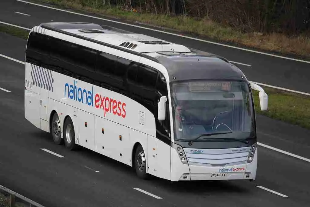 A national express financial coach traveling on a highway.