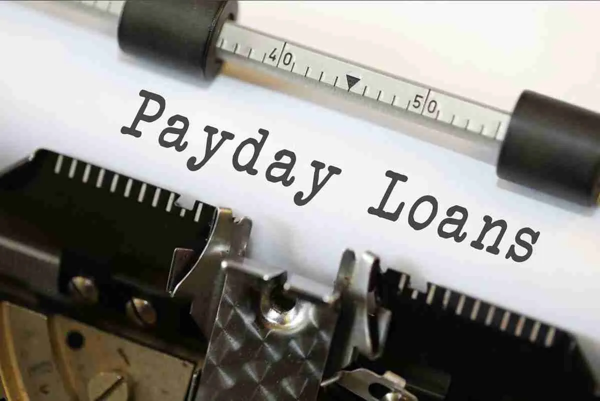 Typewriter with the words "paydayexpress loans" typed out, symbolizing the documentation or discussion of financial services.