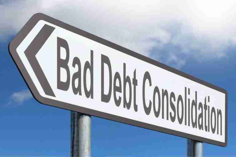 Directional road sign indicating "bad debt consolidation" against a blue sky with clouds.